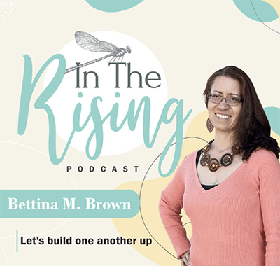 A woman in a coral long sleeve shirt with the title "In the Rising" to her left.